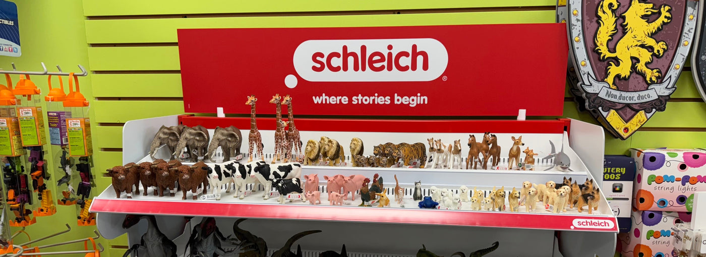 Schleich toy display with various animal figurines in a store setting.